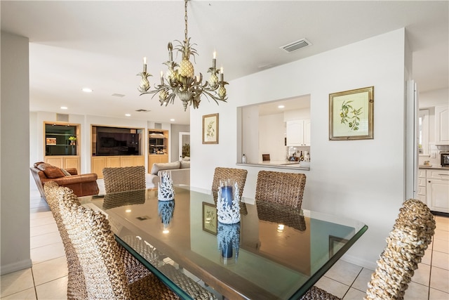 dining area with light tile patterned floors and a notable chandelier