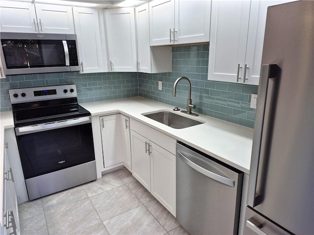 kitchen featuring white cabinets, sink, and stainless steel appliances