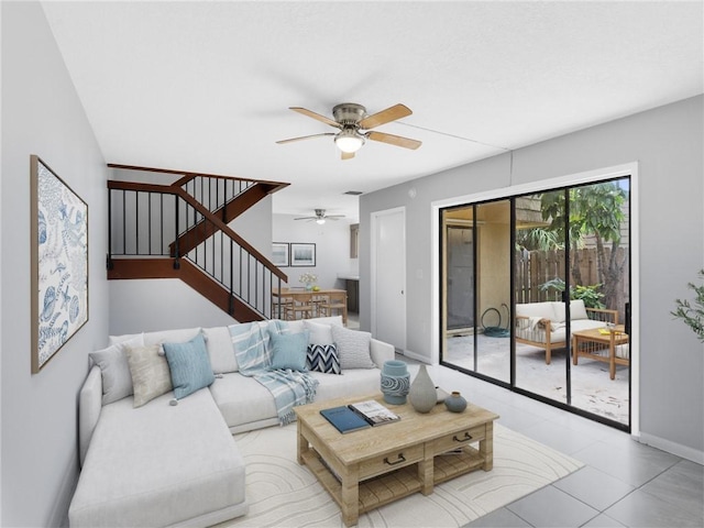 living room with ceiling fan and light tile patterned flooring