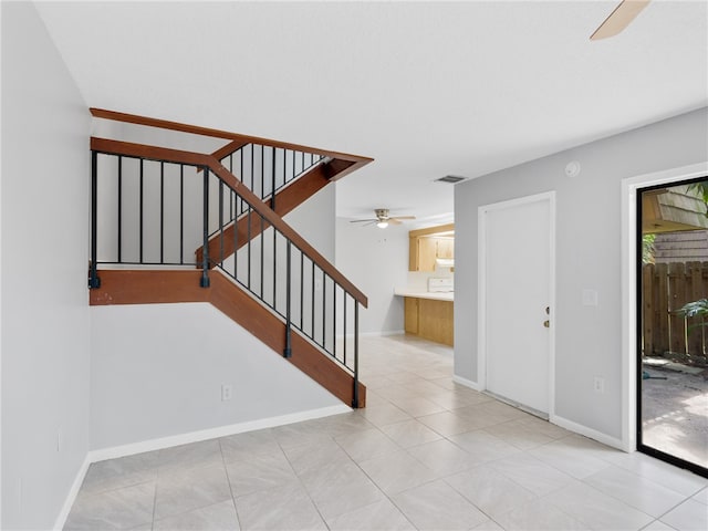 stairway with ceiling fan