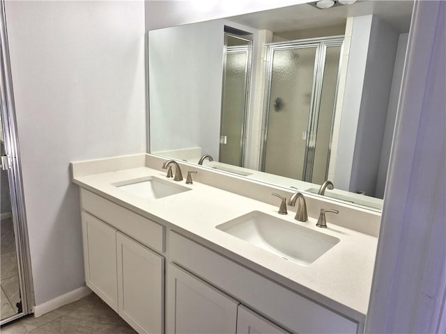 bathroom featuring tile patterned flooring, vanity, and a shower with door