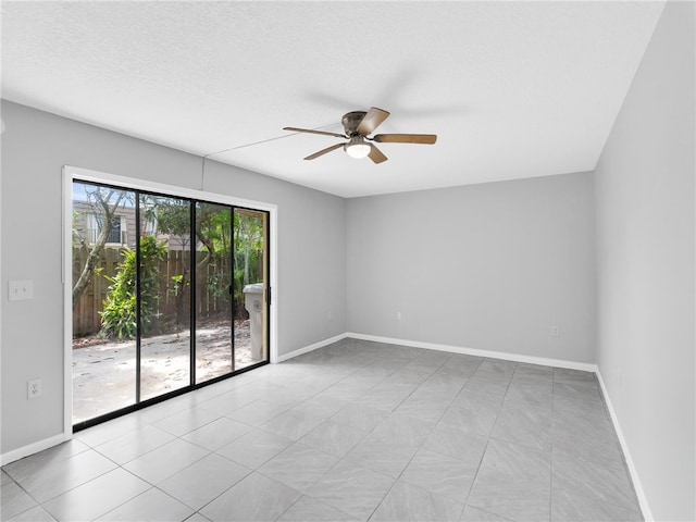 tiled empty room featuring a textured ceiling and ceiling fan