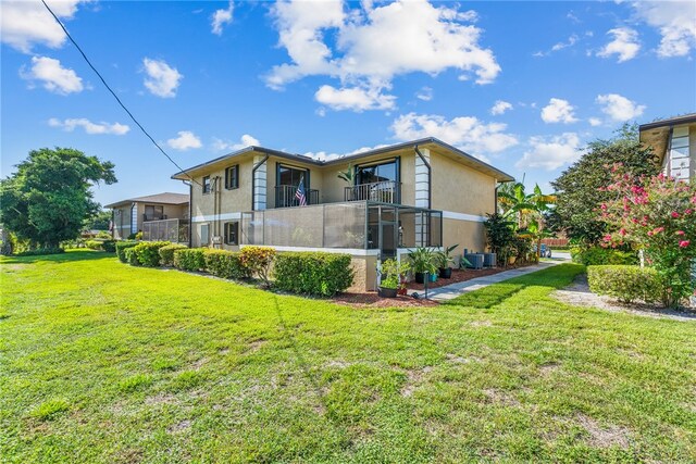 view of property exterior with a balcony and a yard