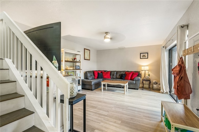 living room with ceiling fan and light hardwood / wood-style floors