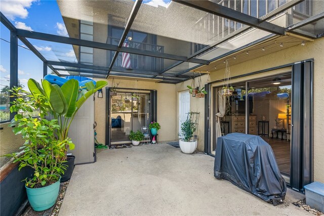 view of patio with glass enclosure