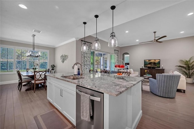 kitchen with visible vents, arched walkways, dishwasher, white cabinets, and a sink