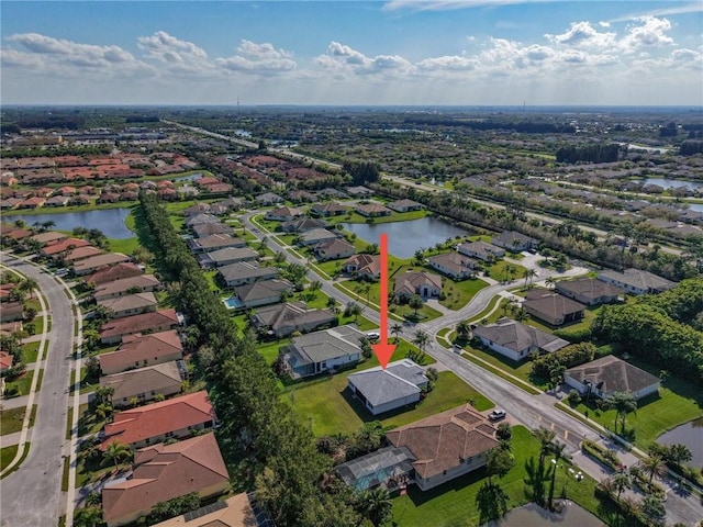 birds eye view of property with a water view and a residential view