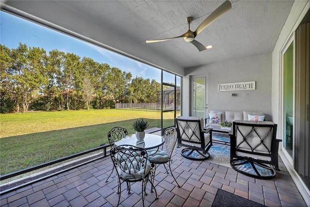 sunroom with a ceiling fan