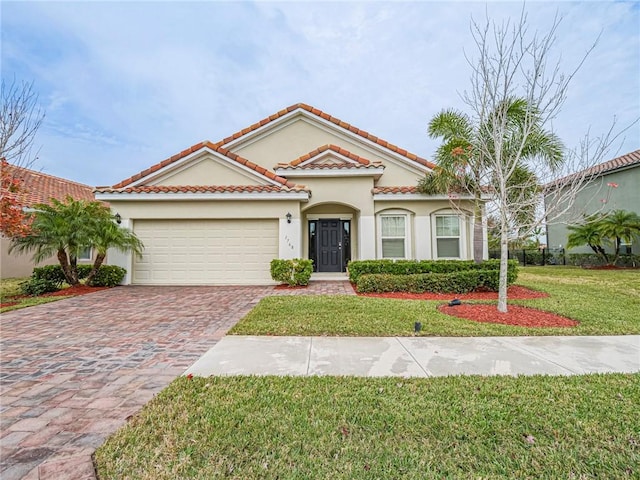 mediterranean / spanish-style house with a front lawn and a garage