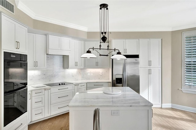 kitchen featuring black appliances, a center island, white cabinets, and hanging light fixtures