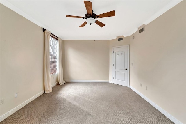 empty room featuring carpet flooring, ceiling fan, and ornamental molding