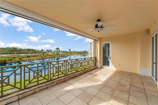 balcony featuring ceiling fan and a water view