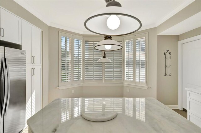 9013 Somerset Bay Ln Unit 201, Vero Beach, FL 32963 - unfurnished dining area featuring crown molding