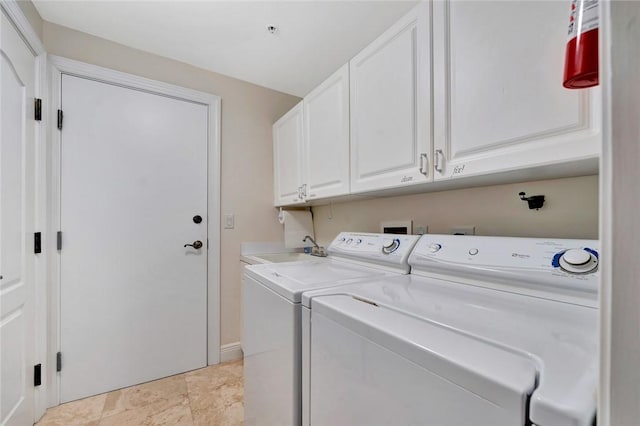 washroom featuring washer and clothes dryer and cabinets