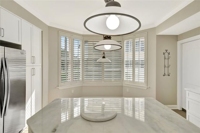 dining space with crown molding