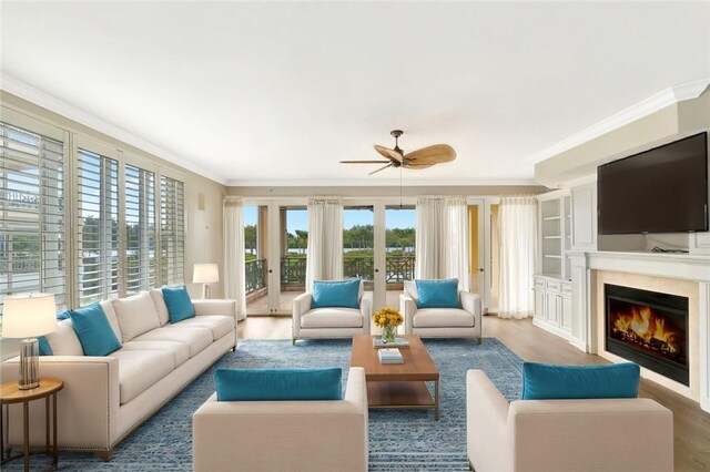 9013 Somerset Bay Ln Unit 201, Vero Beach, FL 32963 - living area featuring ornamental molding, wood finished floors, ceiling fan, and a warm lit fireplace
