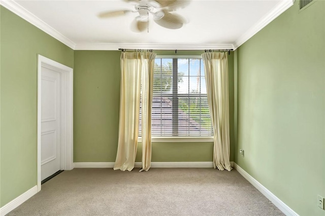 empty room featuring light carpet, crown molding, and ceiling fan