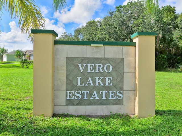 community / neighborhood sign with a yard