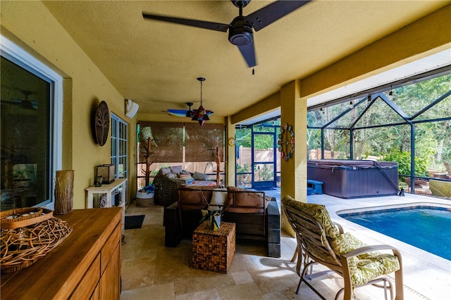 view of patio featuring ceiling fan, a lanai, a swimming pool with hot tub, and an outdoor hangout area