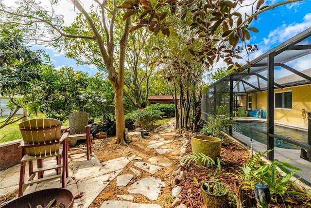 view of patio featuring a lanai