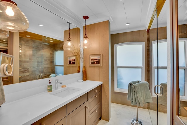 bathroom with an enclosed shower, vanity, and wooden walls