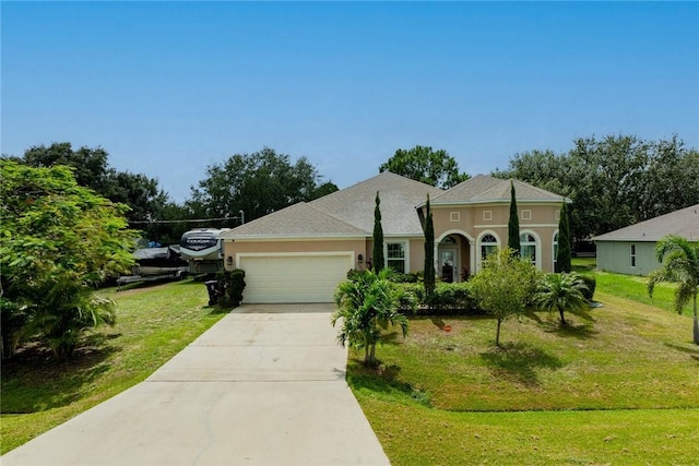5744 Cahaba St, Port St Lucie, FL 34986 - view of front of home with a garage, stucco siding, a front lawn, and concrete driveway