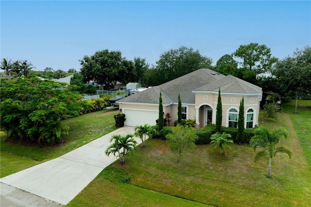 5744 Cahaba St, Port St Lucie, FL 34986 - view of front of property featuring a garage, driveway, a front lawn, and stucco siding
