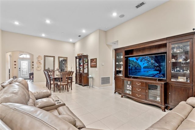 5744 Cahaba St, Port St Lucie, FL 34986 - living room featuring light tile patterned flooring, arched walkways, and recessed lighting