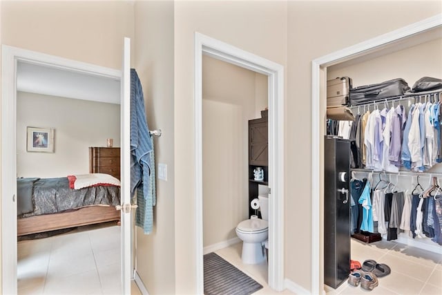 5744 Cahaba St, Port St Lucie, FL 34986 - bathroom featuring tile patterned floors, connected bathroom, and a spacious closet