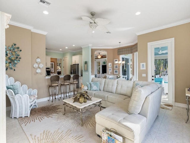 tiled living room featuring crown molding and a notable chandelier