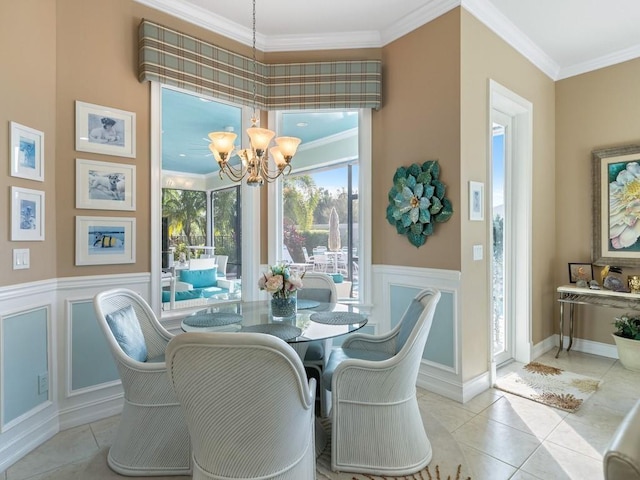 tiled dining area featuring crown molding and a chandelier