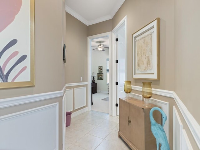 corridor featuring ornamental molding and light tile patterned floors