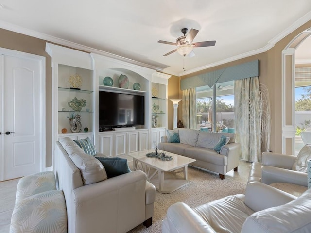 living room with built in shelves, ceiling fan, and ornamental molding