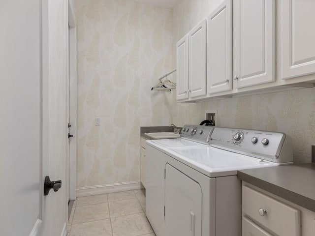 washroom featuring cabinets, light tile patterned floors, washer and clothes dryer, and sink