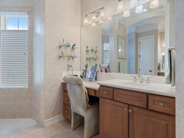 bathroom featuring tile patterned flooring, vanity, and crown molding