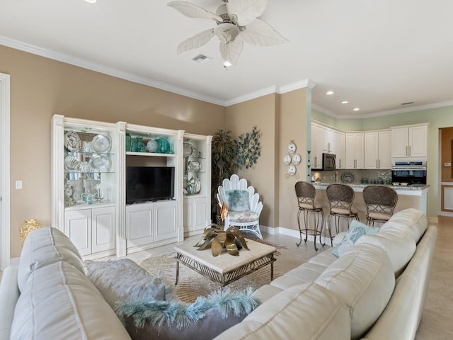 living room featuring ceiling fan and crown molding