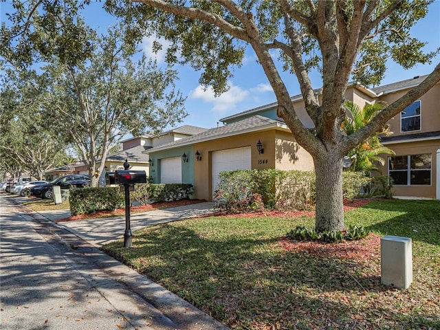 view of front of property featuring a garage and a front lawn