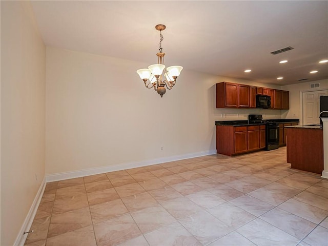 kitchen with a notable chandelier, decorative light fixtures, and black appliances