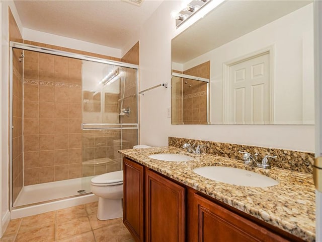 bathroom with tile patterned floors, toilet, an enclosed shower, a textured ceiling, and vanity