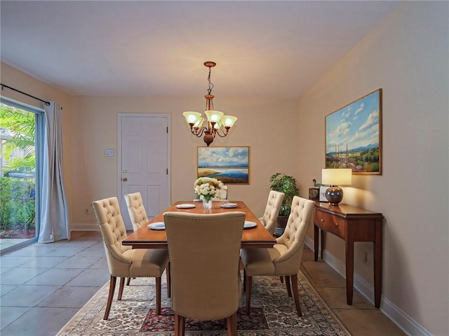 dining room featuring light tile patterned flooring and a chandelier