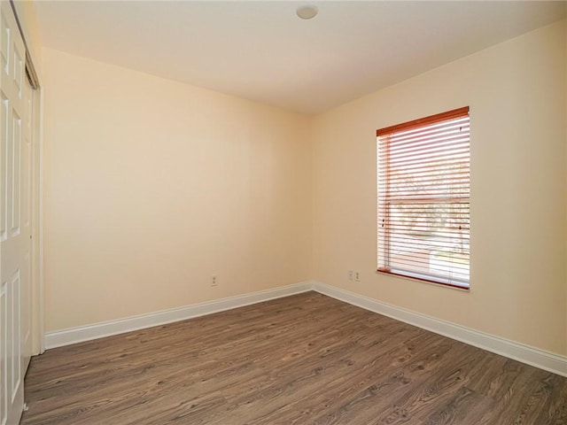 unfurnished room featuring dark hardwood / wood-style flooring