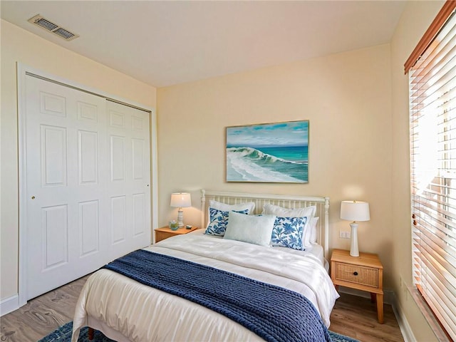 bedroom featuring hardwood / wood-style floors and a closet