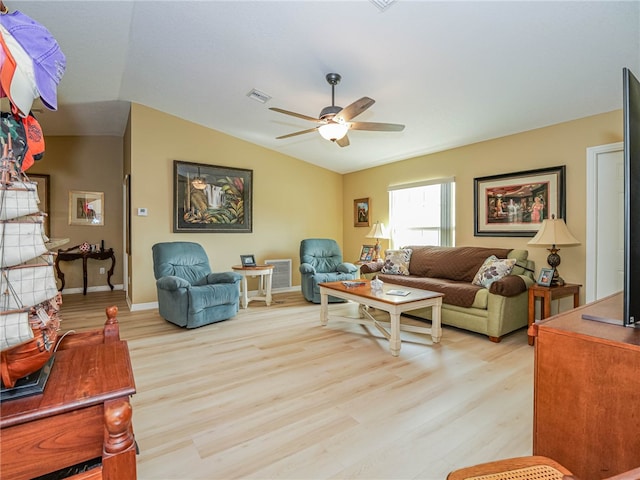 living room with light hardwood / wood-style floors, ceiling fan, and vaulted ceiling