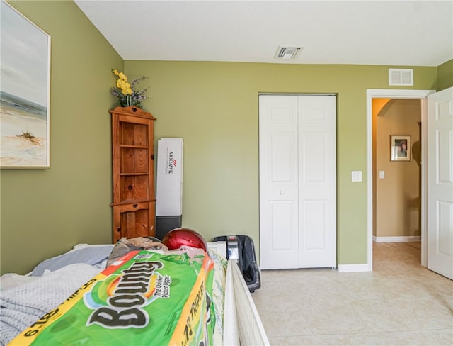 tiled bedroom with a closet