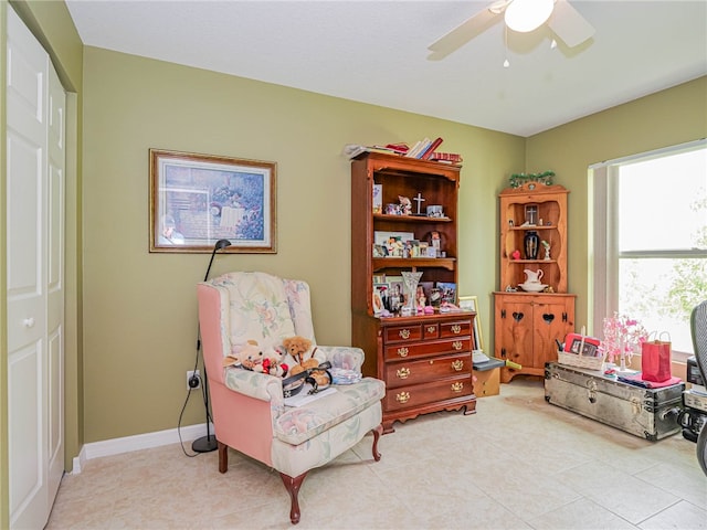 sitting room with ceiling fan and light tile patterned flooring