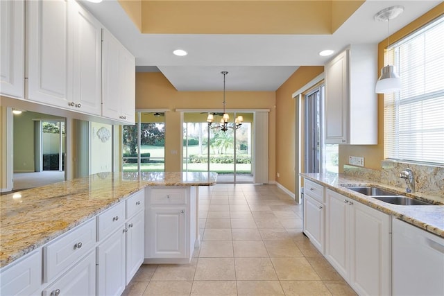 dining room with light wood-type flooring, a wealth of natural light, and ceiling fan with notable chandelier