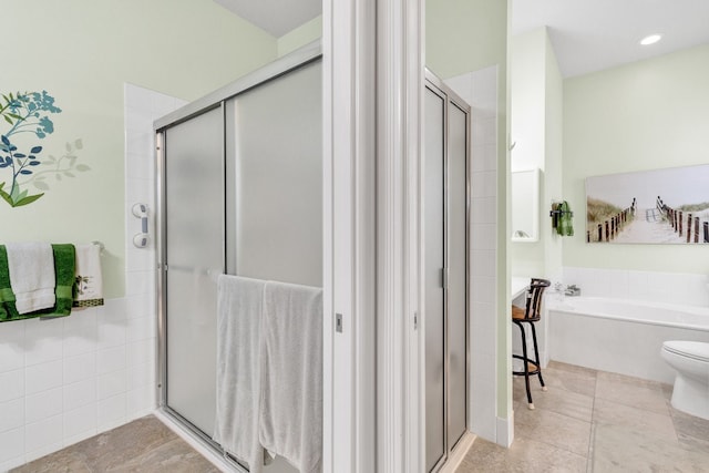 bathroom featuring toilet and plus walk in shower