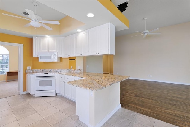 kitchen with a wealth of natural light, white appliances, sink, and white cabinets