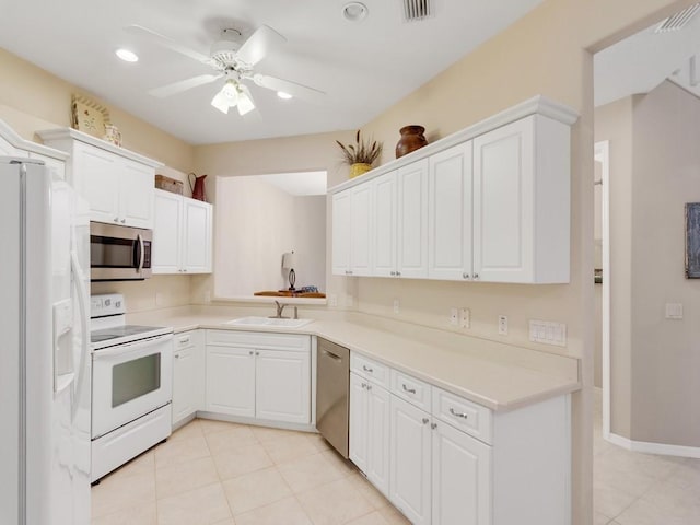 kitchen with visible vents, white cabinetry, a sink, light tile patterned floors, and stainless steel appliances
