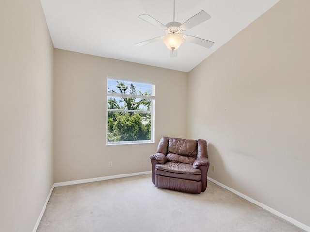 living area featuring carpet floors, baseboards, and ceiling fan